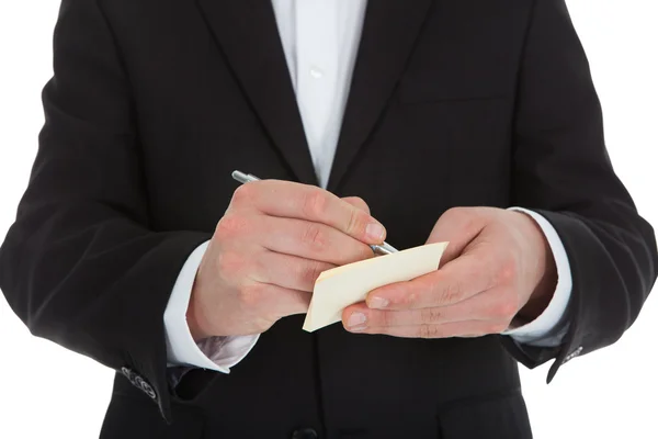 Midsection of waiter writing on notepad — Stock Photo, Image