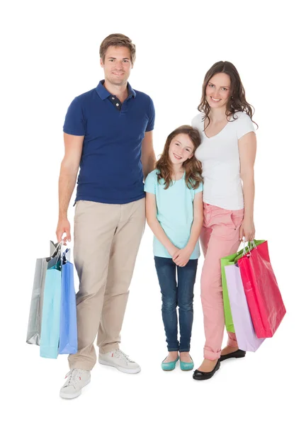 Família sorridente com sacos de compras — Fotografia de Stock