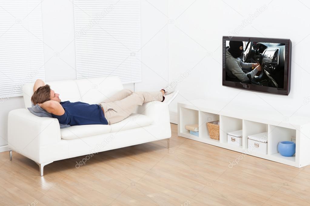 Man Watching TV On Sofa