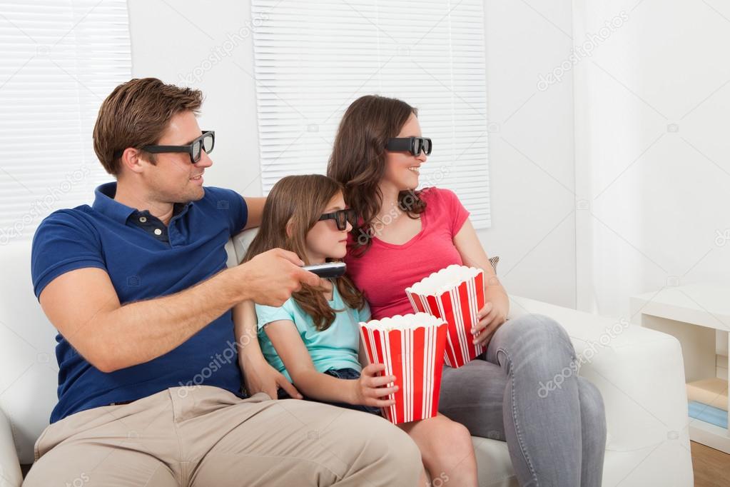 Family in 3D glasses with popcorn