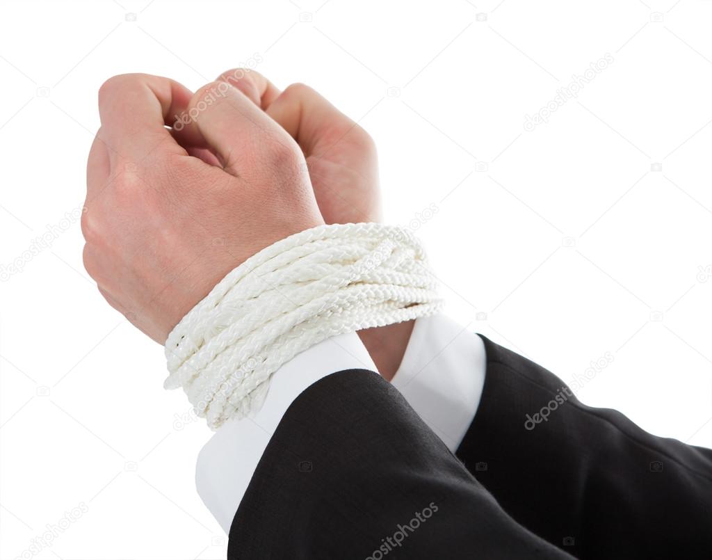 Businessman's Hands Tied With Rope
