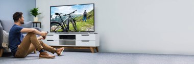 Oturma odasında Bağlı TV Ekranı İzleyen Adam