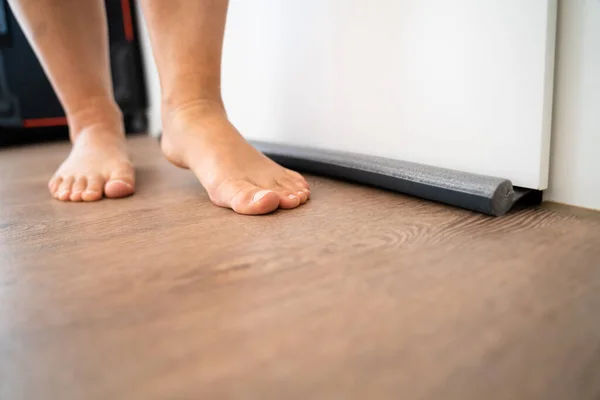 Person Walking Barefoot Draft Excluder Door Blocking Cold Air Traveling — Stock Photo, Image