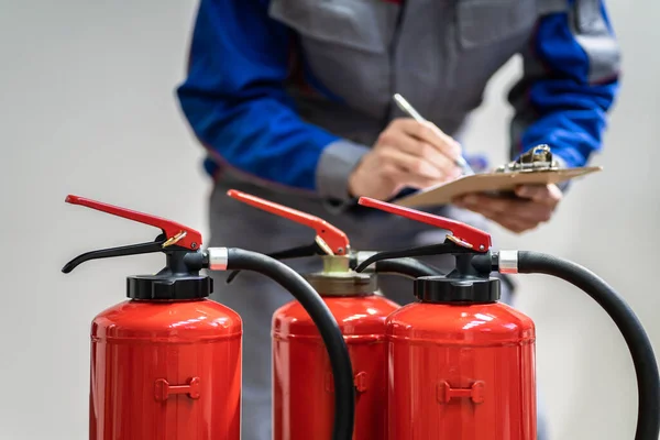 Fire Extinguisher Safety Prevention Check. Emergency Equipment Inspection