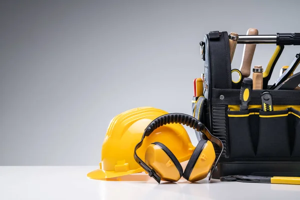 Various Manual Tools And Hardware In Toolbox On Gray Background