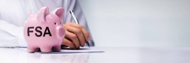 FSA - Flexible Spending Account. Piggybank And Money Savings Concept