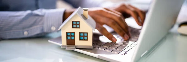 Immobilienhaus Modell Der Nähe Von Laptop Auf Dem Schreibtisch — Stockfoto