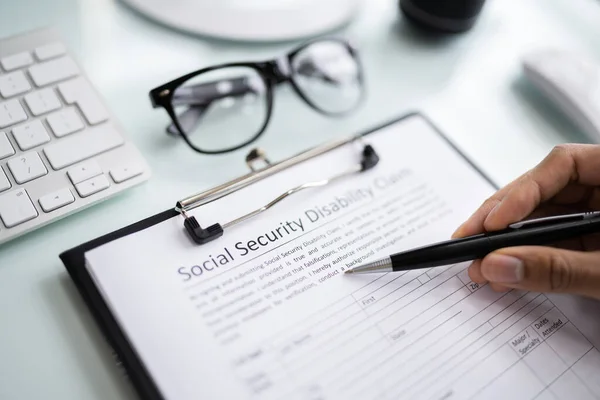 Close Person Hand Filling Social Security Benefits Application Form — Stock Photo, Image