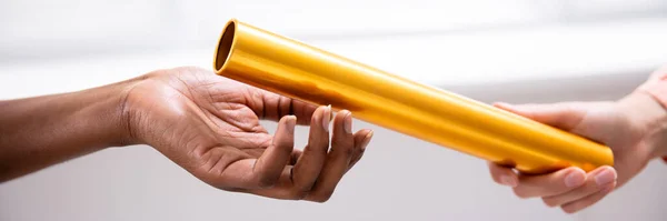 Close Hand Passing Golden Relay Baton African Woman Hand — Stock Photo, Image