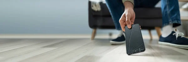 Primer Plano Hombre Recogiendo Teléfono Inteligente Roto Del Piso Madera —  Fotos de Stock