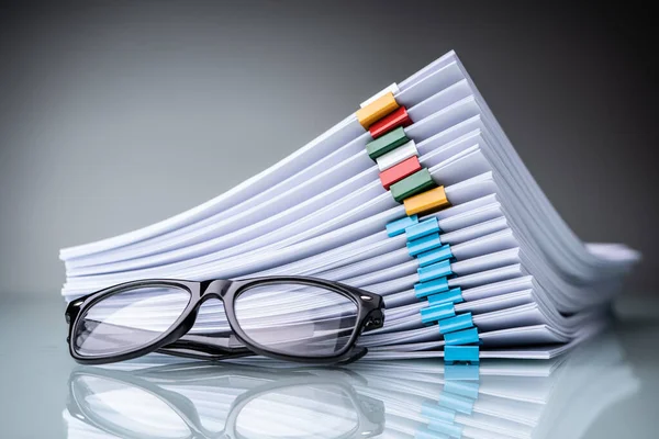 Gestapelte Dokumente Mit Bunten Büroklammern Und Brillen — Stockfoto