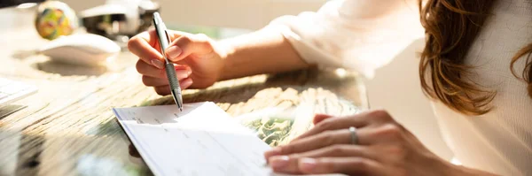 Businesswoman Hand Signing Cheque Wooden Desk — Stock Photo, Image