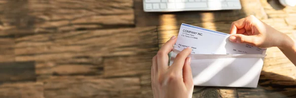 Close Businessperson Hand Opening Envelope Paycheck Wooden Desk — Stock Photo, Image