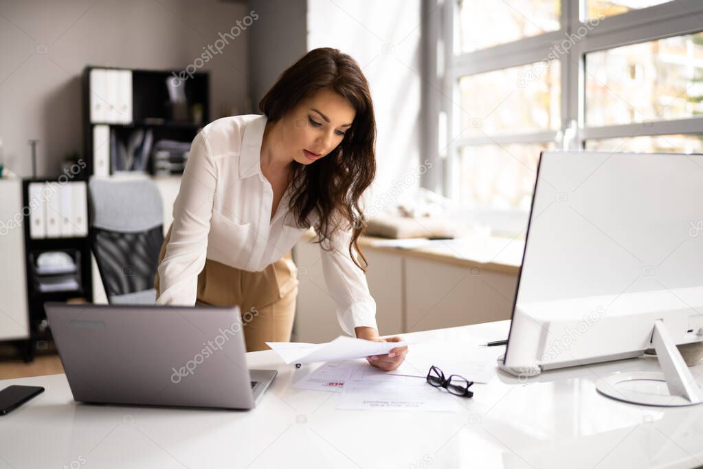 Accountant Woman Using Office Computer To Calculate Invoice