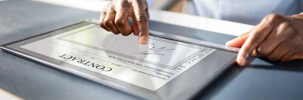 Close-up Of A Businessman\'s Hand Working With Invoice On Digital Tablet