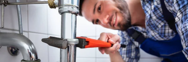 Young Male Plumber Repairing Sink Adjustable Wrench Bathroom — Stock Photo, Image
