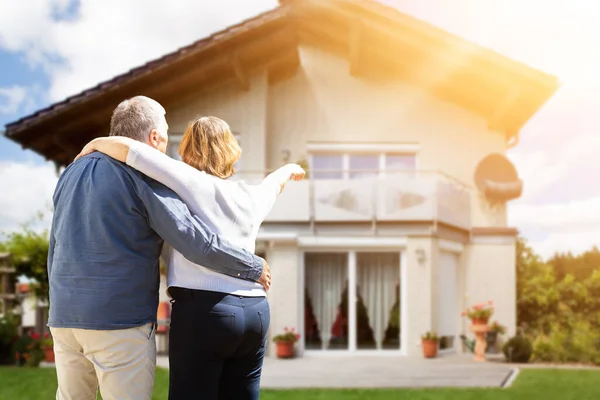 Rear View Senior Couple Pointing Finger Front House — Stock Photo, Image