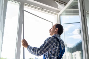 Mosquito Net Frame Install Service. Worker At Home