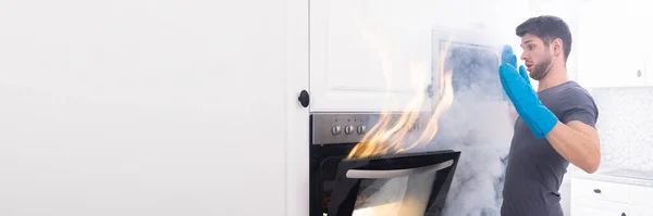 Afraid Young Man Looking Fire Coming Out Oven Kitchen — Stock Photo, Image