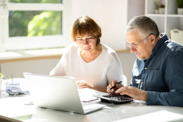 Elderly Woman Checking Accounts While Husband Adds Figures Calculator — Stock Photo, Image