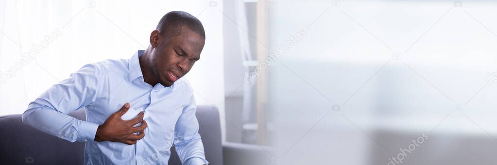Portrait Of A Young African Man Suffering From Chest Pain
