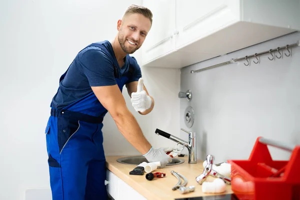 Happy Young Male Plumber Fixing Faucet Kitchen — Stock Photo, Image