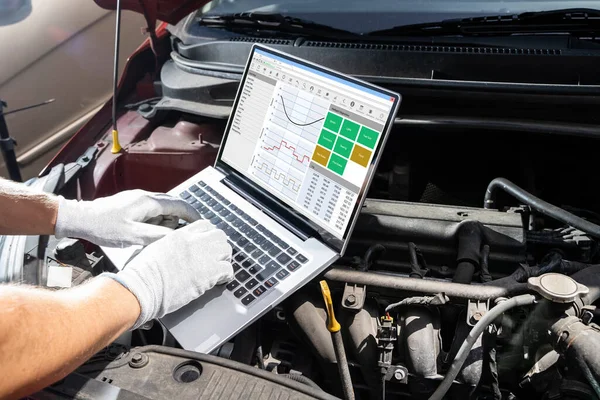 Male Mechanic Muda Menggunakan Laptop Ketika Sedang Memeriksa Mesin Mobil — Stok Foto