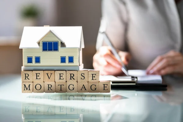 House Model Reverse Mortgage Blocks Front Businesswoman Writing Paper Desk — Fotografia de Stock