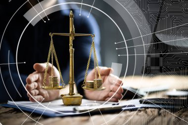 Midsection of businessman protecting justice scale with coins at table