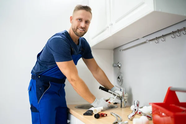 Happy Young Male Plumber Fixing Faucet Kitchen — Stock Photo, Image