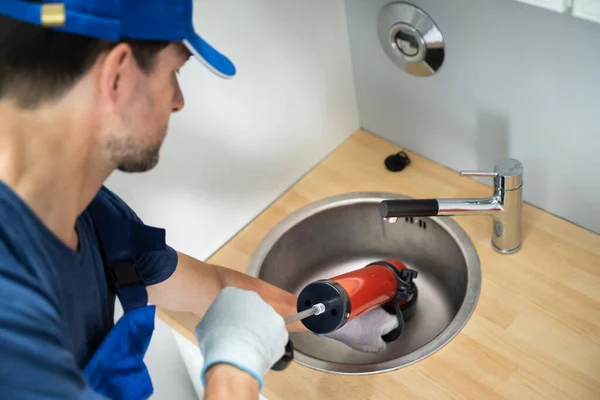 Plumber Cleaning Drain Sink Using Pump — Photo