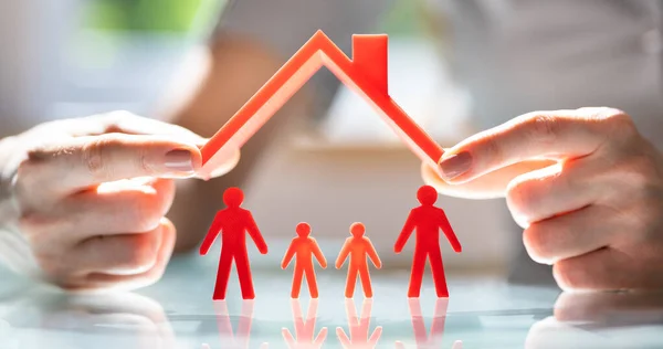 Close Person Hand Protecting Family Figures Red Roof — Stock Photo, Image