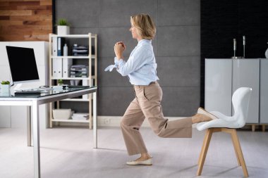 Squat Employee Doing Bulgarian Split Squat Exercise In Office