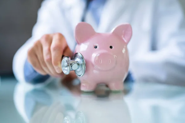 Midsection Young Male Doctor Holding Piggybank Clinic — Stockfoto