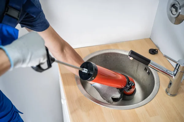 Plumber Cleaning Drain Sink Using Pump — Fotografia de Stock