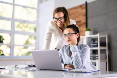 Woman Training On Laptop Computer Wearing Eyeglasses At Workplace