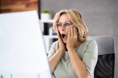 Frustrated Businesswoman Looking At Her Computer Screen In Dismay clipart