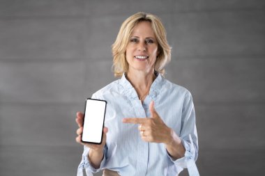 Senior Grandmother Showing Mobile Phone. Holding Smartphone