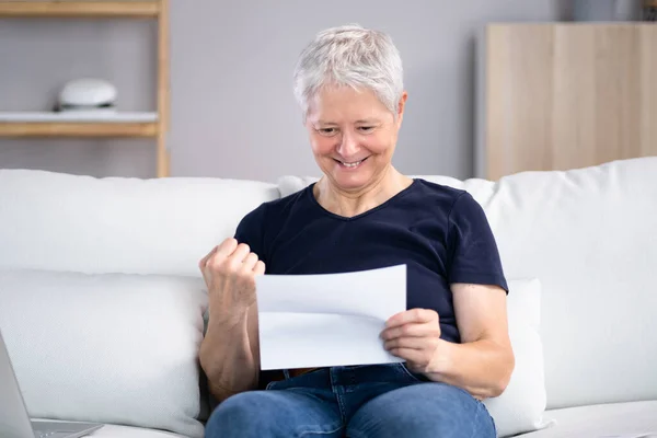 Smiling Woman Reading Letter While Sitting Sofa Home —  Fotos de Stock