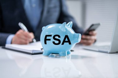FSA - Flexible Spending Account. Piggybank And Money Savings Concept