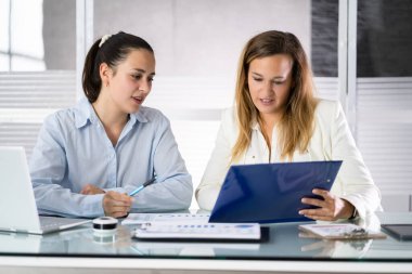 Two Businesspeople Analyzing Financial Graph And Data