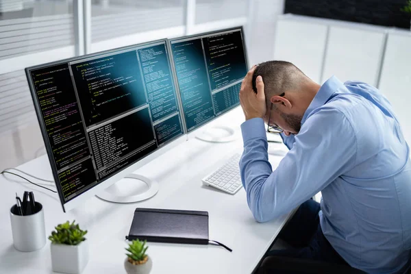 Unhappy Sad Developer Programmer Man In Stress Coding Software On Computer