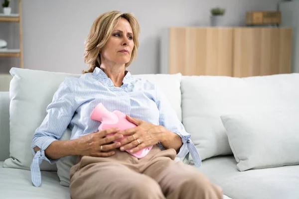 Woman Suffering Stomach Pain While Lying Sofa Home — Stockfoto