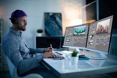 Graphic Designer Working Late At Night In Office