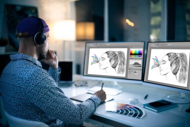 Graphic Designer Working Late At Night In Office