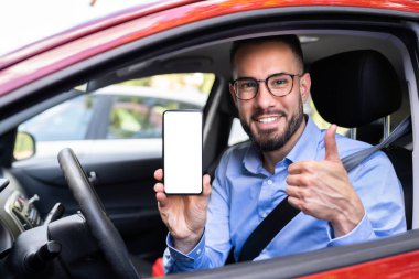 Man Hand Showing Mobile Phone In Car