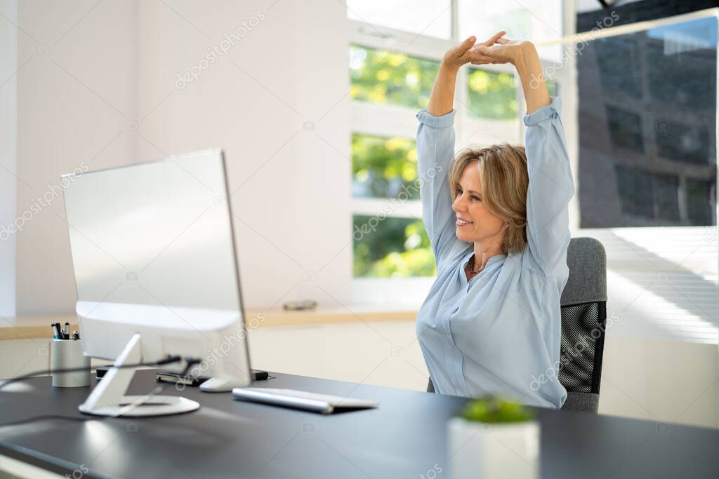 Stretch Arm Exercises While Working At Office Computer