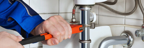 Plumbing Home Repair Service. Plumber Fixing Bathroom