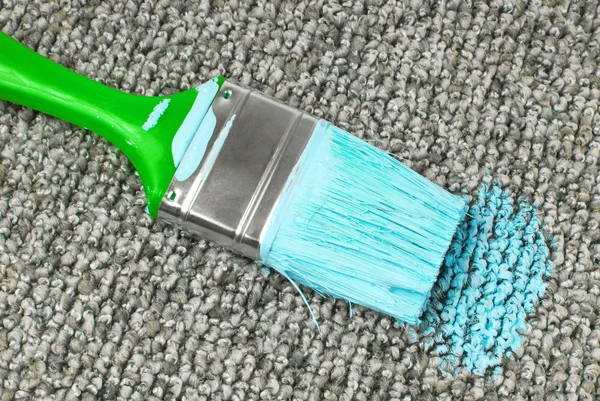 Stained carpet with paint brush — Stock Photo, Image