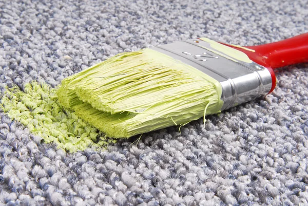 Paint brush on stained carpet — Stock Photo, Image